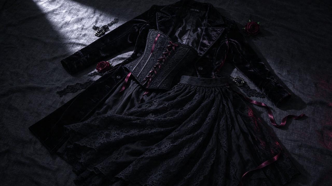 Flat lay of black gothic clothing and lace fabrics